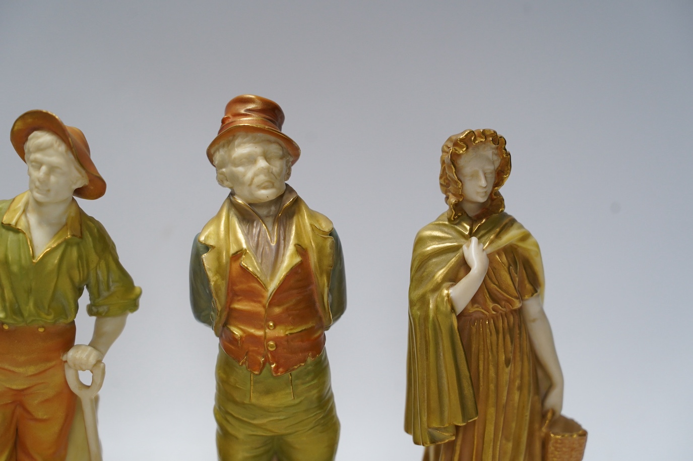 Four Worcester figures comprising 1874, 1810 and 835, one signed Hadley, largest 17cm high. Condition - good